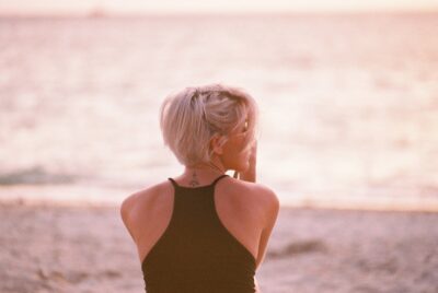 woman wearing black halter top facing beach